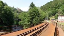 Pohled na silniční most přes Kamenici (Spálovské soumostí) a železniční zastávku Spálov z železničního mostu přes Jizeru. Datum: 11.06.2019.