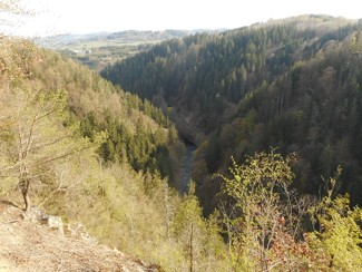 Pohled z vyhlídky U Bakala na kaňon Jizery s Riegrovkou a Říkovskými železničními tunely. Datum: 18.04.2020.